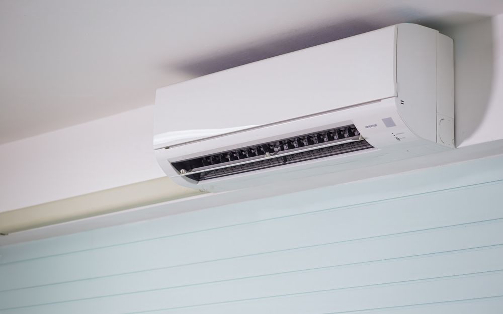 A wall-mounted split-system air conditioner with the louvre open